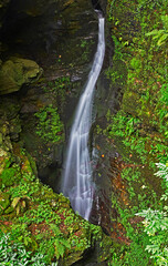 Naklejka na ściany i meble Dropping water at St Nectan's waterfall in Cornwall