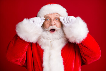 Close up photo of astonished santa claus touch spectacles x-mas shopping discounts wear red costume...