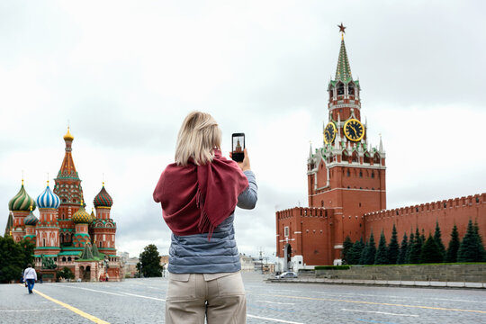 Tourist woman taking photo on her smartphone on Red Square in Moscow, Russia.