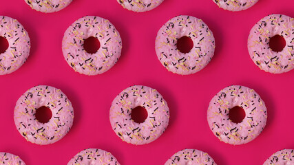 Festive creative pattern of rows of pink donuts on pink background