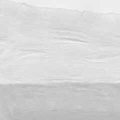 Obraz premium White torn paper collage close-up. Texture made from various paper and cardboard parts. Damaged old paper background. Vintage blank wallpaper. Material design backdrop.