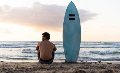 Young caucasian man get up early to doing surf at sunrise