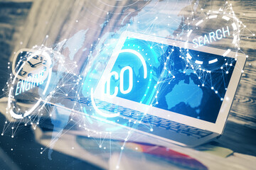 Double exposure of blockchain theme hologram and table with computer background. Concept of bitcoin crypto currency.