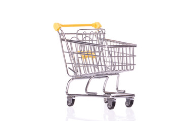 empty toy shopping trolley isolated on white background. Symbol of consumer society. Purchase concept. Black Friday. Lack of goods, supply disruptions concept.