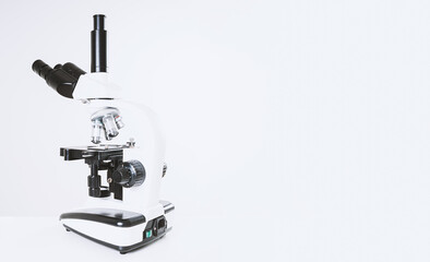 Using a biological microscope. Close up of a microscope. Scientific research concept, using a microscope. Medical examinations, searching for bacteria, diseases, blood tests.