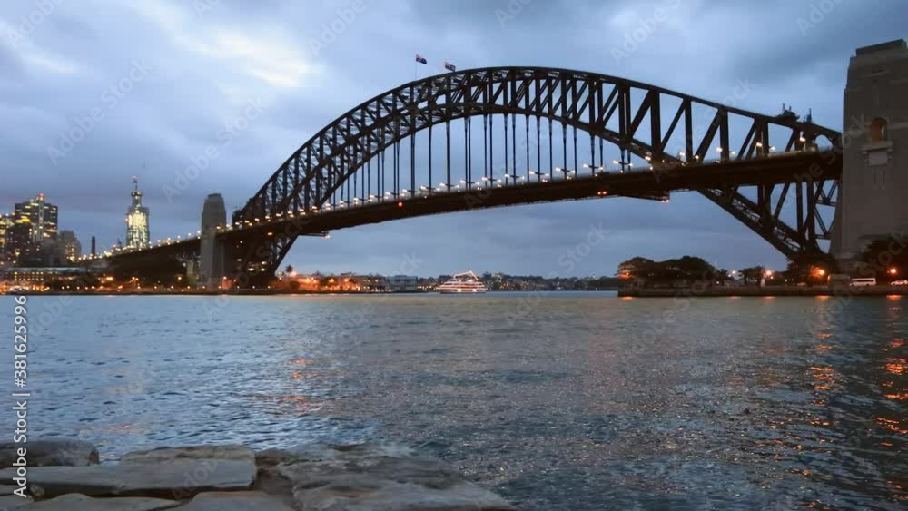 Poster Slow panorama of Sydney city CBD waterfront at night near Bridge as 4k.
