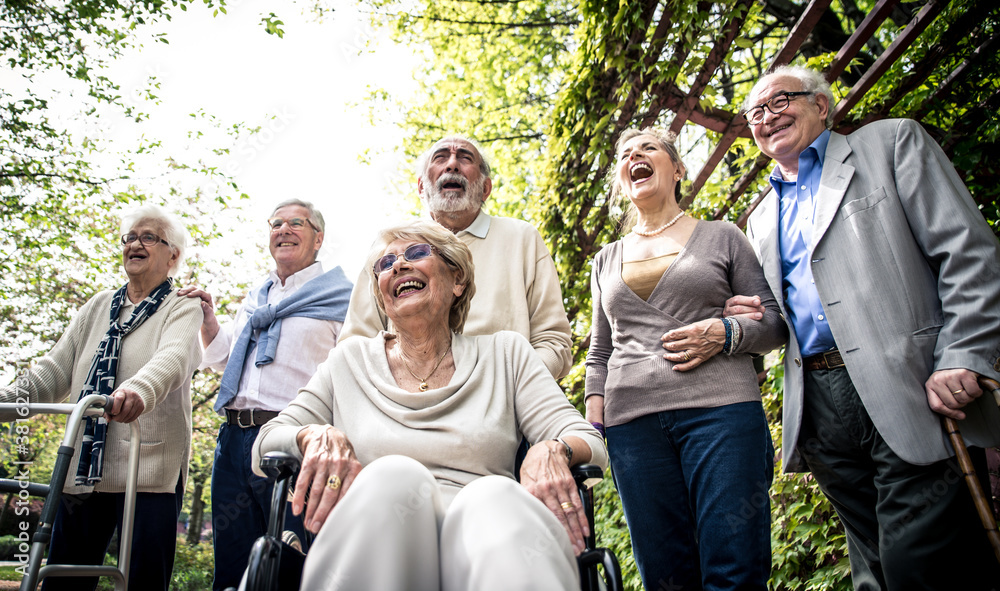 Wall mural group of old people walking outdoor