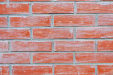 Fototapeta premium Red brick wall texture background of a house. Close up macro.