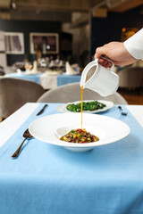 Spanish traditional oxtail soup in white plate