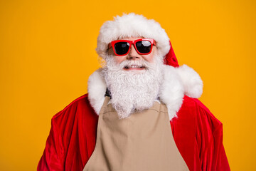 Close-up portrait of his he nice attractive confident cheerful cheery grey-haired Santa father wearing apron shop business owner isolated over bright vivid shine vibrant yellow color background