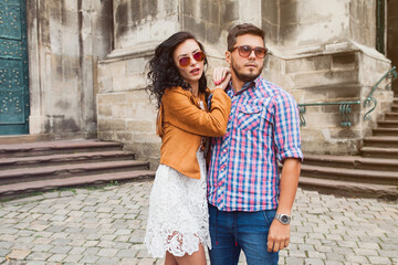 young couple in love traveling, vintage style, europe vacation, honey moon, sunglasses, old city center, happy positive mood, smiling, embracing