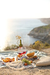 picknick outdoors with fruits and wine by sea in naure
