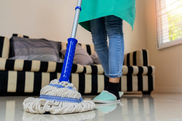 Cleaning her house by mopping the floor