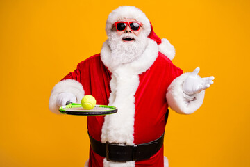 Fototapeta na wymiar Portrait of his he nice attractive cheerful fat overweight Santa enjoying playing badminton team spirit spend time isolated over bright vivid shine vibrant yellow color background