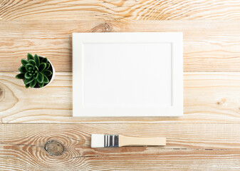 Minimal artist mockup with brushes on wood table flat lay