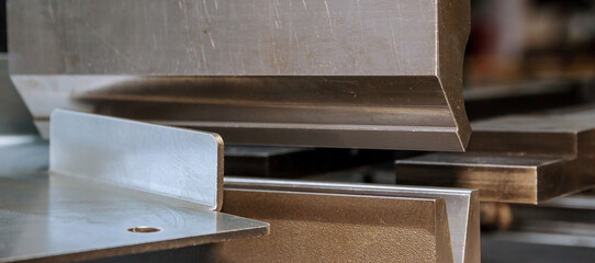 Bending sheet metal on a hydraulic machine at the factory. Bend tools, press brake punch and die....