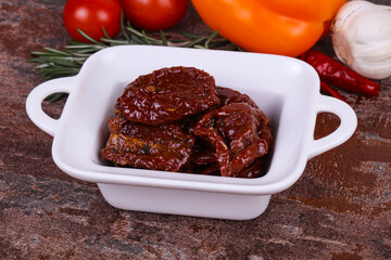 Dried tomatoes in the bowl with olive oil