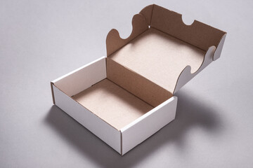 White carton cardboard box for postal shipping on grey background