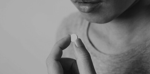 Fototapeta premium Close-up images of people taking or holding a medicine pill in hand which help and protect from pandemic virus and relief them from unhealthy and sickness. studio shot and clear background.