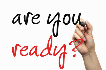 Are you ready phrase on a whiteboard, written with marker in a hand.