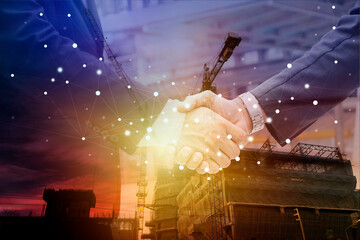 Two confident business man shaking hands during a meeting in the office, success, dealing, greeting and partner concept. Silhouette heavy industry