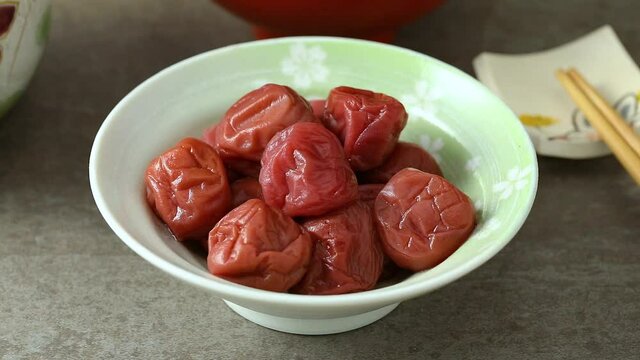 Bowl with traditional Japanese umeboshi close up