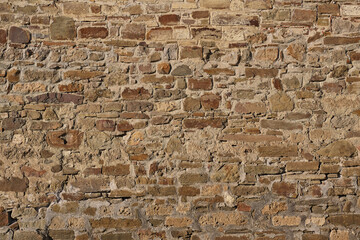 Texture of a stone brown wall of an ancient fortress