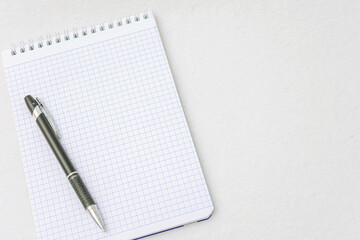 Notebook and  black pen, top view, white background, copy space