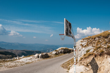 Basketball hoop on Durmitor mountains road. Sport activity in a mountain village © photoguns
