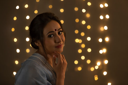 Woman in a saree smiling 	