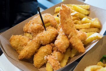 Delicious and unhealthy fast food - golden chicken nuggets with french fries