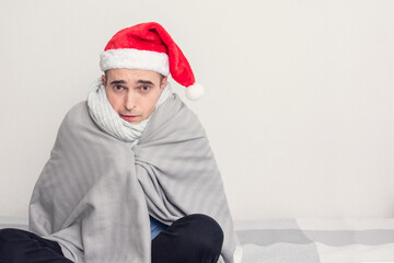 Unhappy Santa sitting at home on self-isolation, portrait, white background, copy space