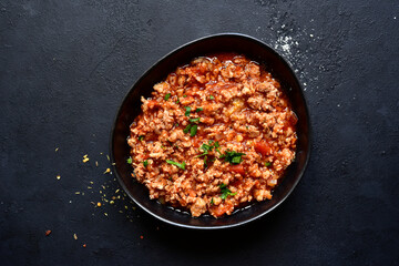 Traditional italian tomato sauce bolognese with minced meat. Top view with copy space.