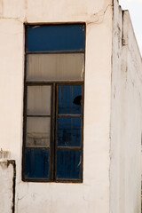 Fototapeta na wymiar broken glasses of an outdoor window of a building in a town