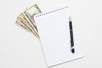 USA dollars and notebook, pen, white background, copy space, mock-up