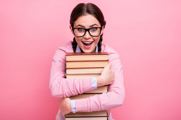 Close-up portrait of her she nice attractive pretty amazed cheerful cheery addicted genius brown-haired teenage girl embracing pile book science lover isolated on pink pastel color background - Powered by Adobe