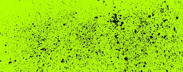 Schwarze Farbspritzer, Flecke und Kleckse auf gelb grünem Hintergrund