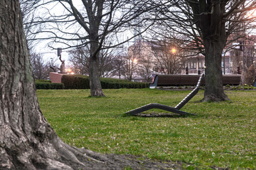 Wooden deck chair on the lawn (city).