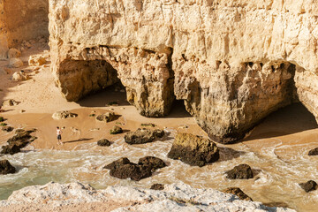 Rock arch by the beautiful sandy beach in Portugal.