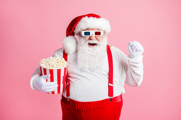 Portrait of his he nice attractive cheerful cheery glad bearded fat Santa watching comedy film...