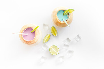 Drink in raw coconut with straw, top view