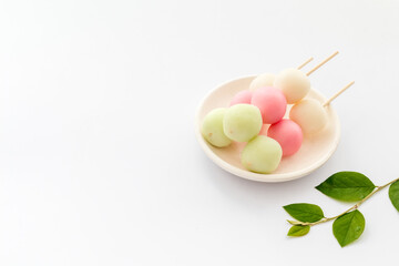 Japanese Dango dessert in pink, white and green colors, copy space