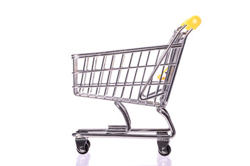Shopping concept. empty toy shopping trolley isolated on white background side view. Idea for discount, e-commerce, online shopping, sale. Symbol of consumer society. Purchase concept