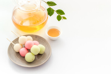 Japanese food background with sweets and tea. Three colored dumplings Dango