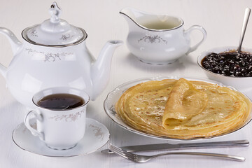 delicious tea with hot pancakes, jam and thick sour cream