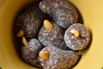 Cashew balls ( Cajuzinho ). Brazilian food, Comida brasileira, Brasil. Typical Brazilian sweet with the main ingredients: condensed milk, peanuts and cocoa powder rolled over crystal sugar