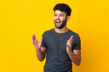 Young Moroccan man isolated on yellow background with surprise facial expression