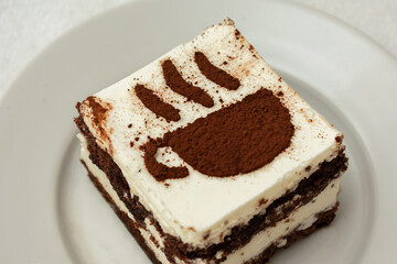 Slice chocolate cake, drawing in the form of a Cup of coffee, top view, closeup