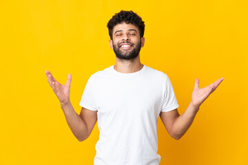 Young Moroccan man isolated on yellow background smiling a lot