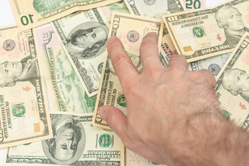 Man fumbles with the money, hand with dollar bills, male hand, close-up
